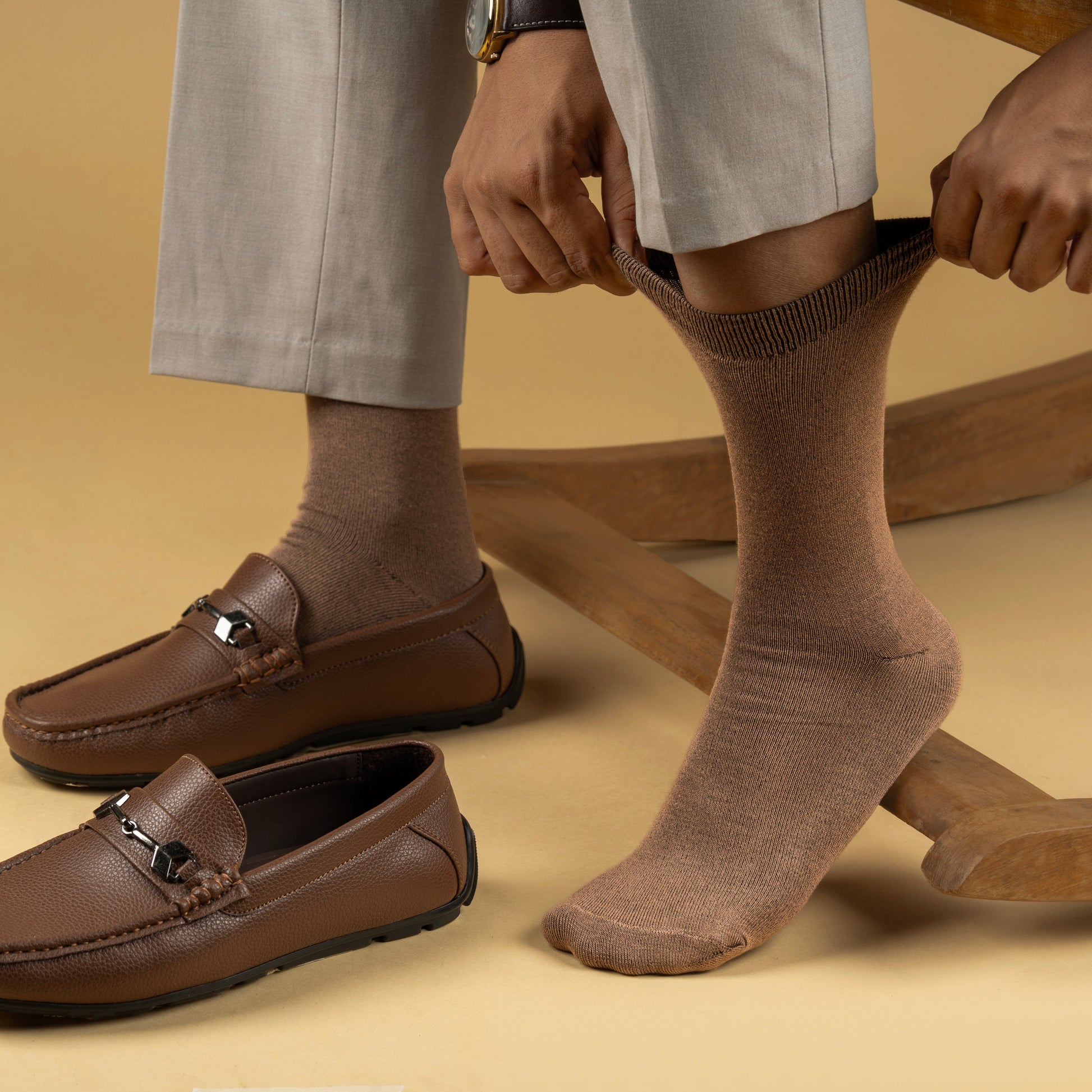 Men wearing Brown socks and loafers on a beige background